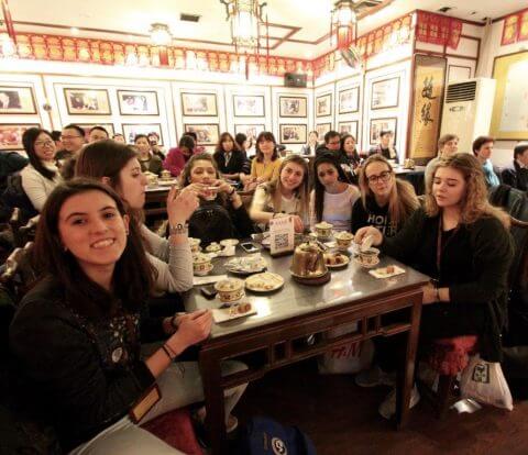 Italian students enjoying a Chinese dinner at a restaurant. 